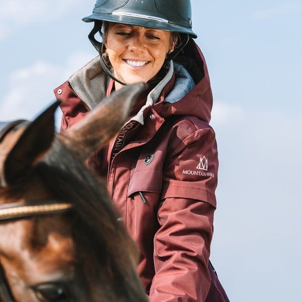 Mountain Horse brand image person with helmet on horse